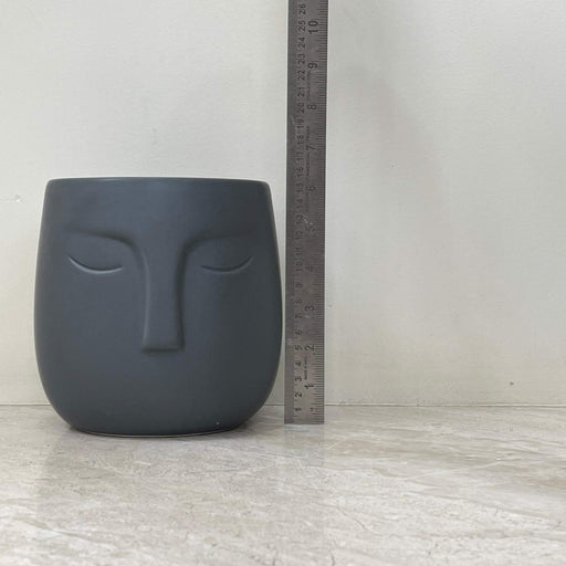 serene face design ceramic planter in dark gray