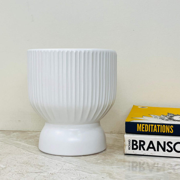 Sleek ribbed white ceramic planter, perfect for home décor.