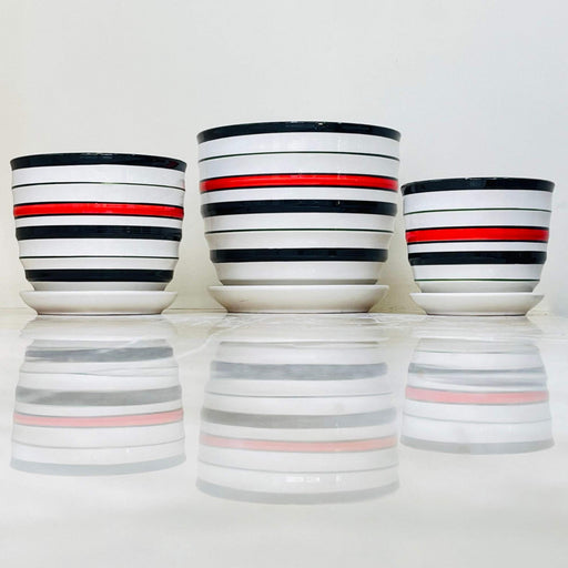 Ceramic pot set with bold black and red stripes on white background