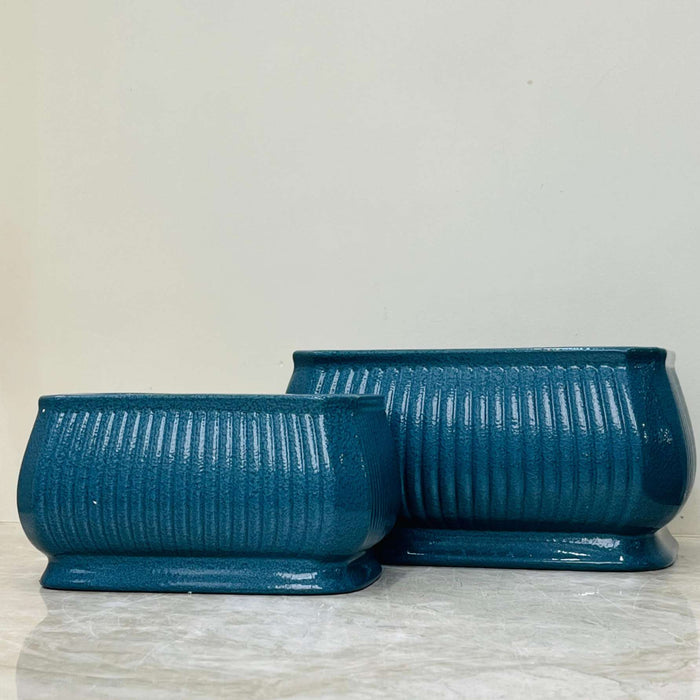 Stylish teal ceramic planter set with glossy finish and ribbed design