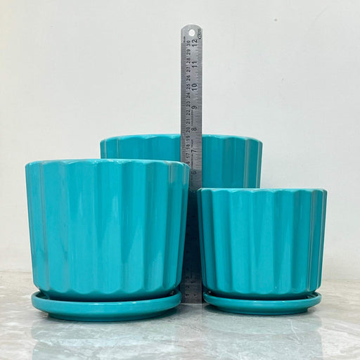 Teal ceramic plant pots with ribbed design