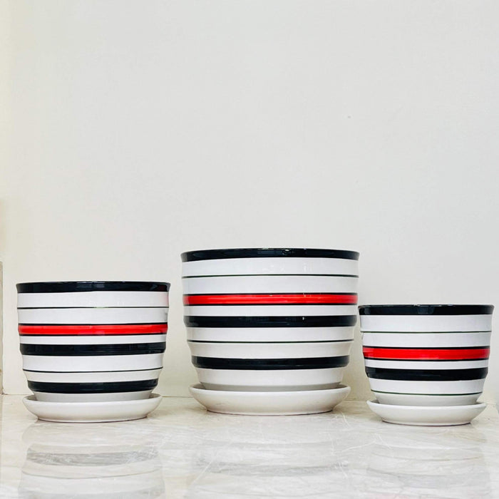 Stylish ceramic planters with contrasting black and red stripes