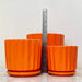 Bright orange ceramic plant pots with ribbed design