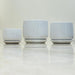 Elegant white ceramic pots with saucers