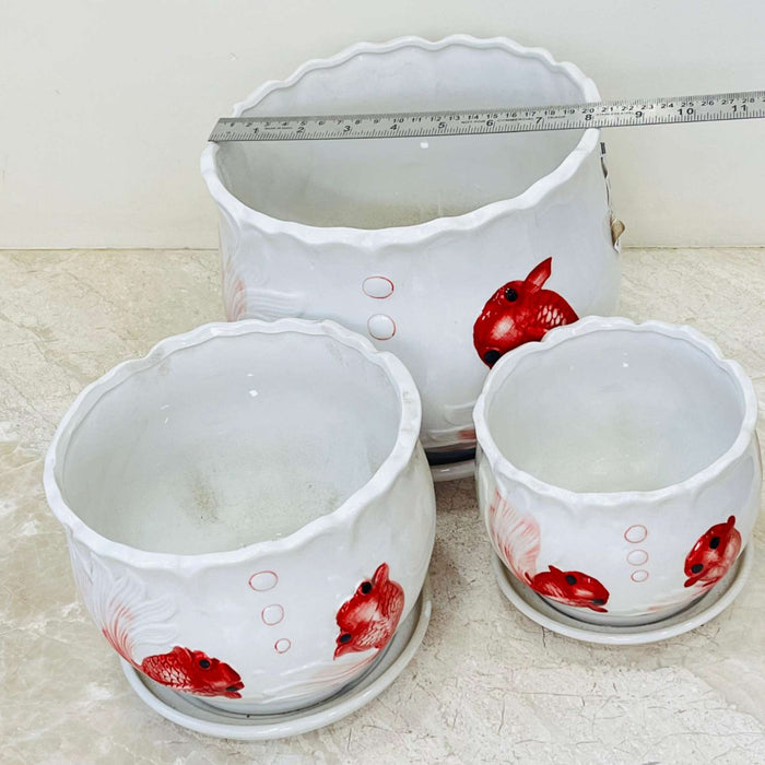 Decorative white ceramic pots with matching saucers