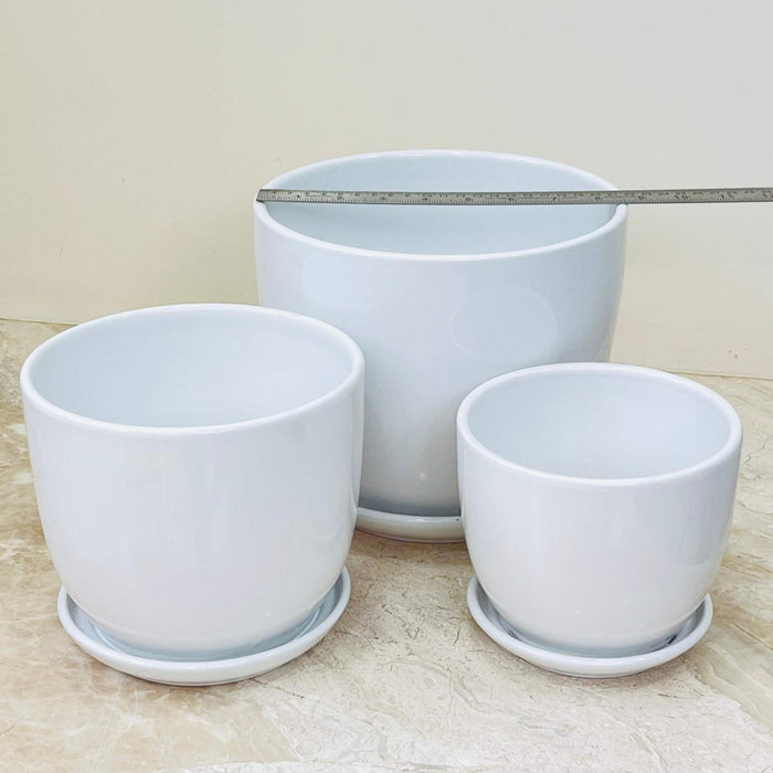 Three-piece white ceramic pot set with a glossy finish