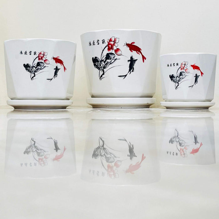 White ceramic pots with black and red koi fish and floral design