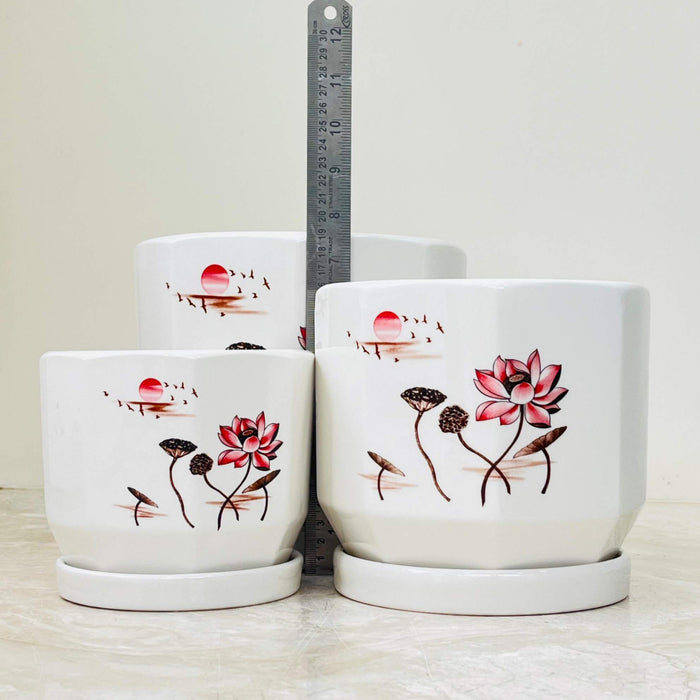 Ceramic planters featuring hand-painted lotus and sun scene