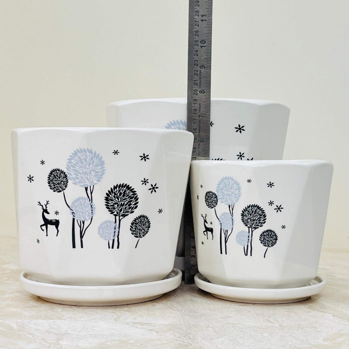 Ceramic planters with nature-inspired tree and deer motif