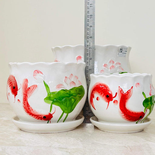 White ceramic planters with red fish design