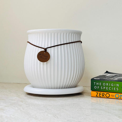 White ribbed ceramic flower pot with leather string and metal tag