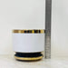 White ceramic planter with gold rim and black base