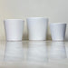 Set of white matte ceramic pots in three sizes