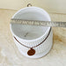 Matte white ceramic planter with decorative tag