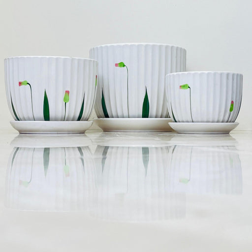 White ribbed ceramic planter set with floral design