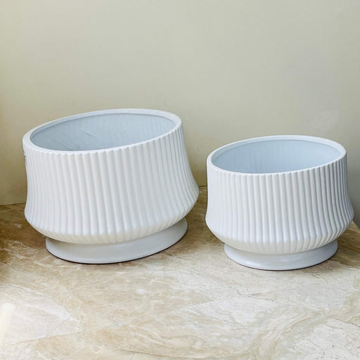 White ribbed ceramic planter with tilted design