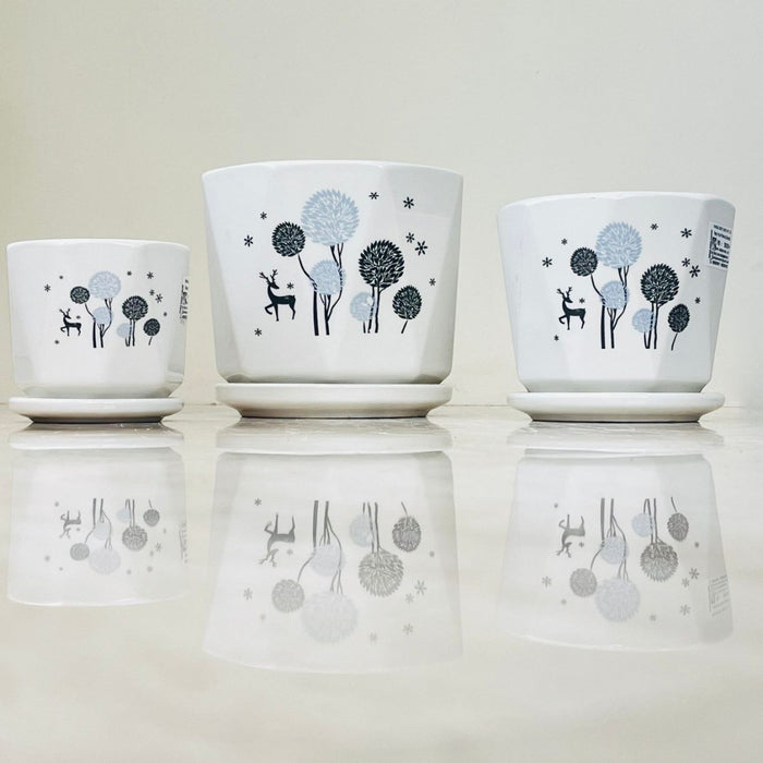 Nature-inspired ceramic pots with reindeer and trees